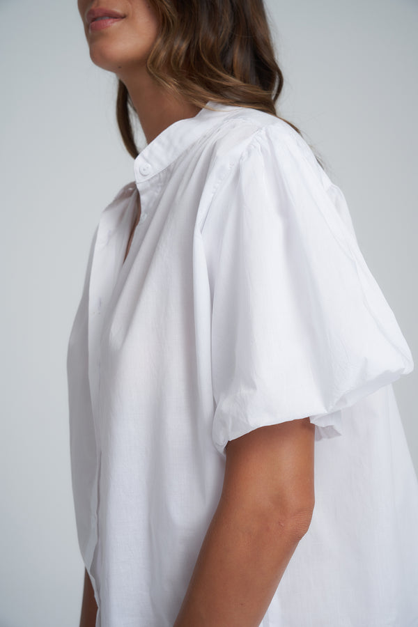 A Model Wearing a Crisp White Cotton Top