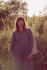 Olivia wearing the blue mesh set in her garden, the perfect everyday outfit.