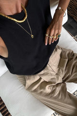 Model wears lightweight knit top in black by Lilya