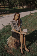 A model wearing black longline linen shorts