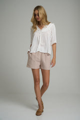 A woman wearing cotton check shorts with elastic waist