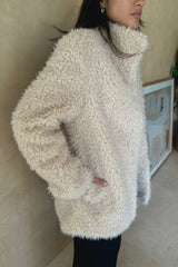 Model wears winter jacket with pockets and collar