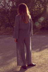 Back view of Olivia wearing the Fenton mesh pants as a set with the Allegra mesh top in a deep blue colour.
