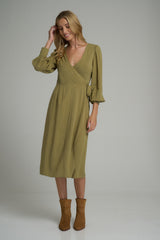 A model wearing a green reversible wrap dress