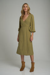 A model wearing a feminine green midi wrap dress