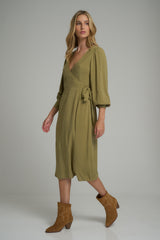 A model wearing a pesto green wrap dress