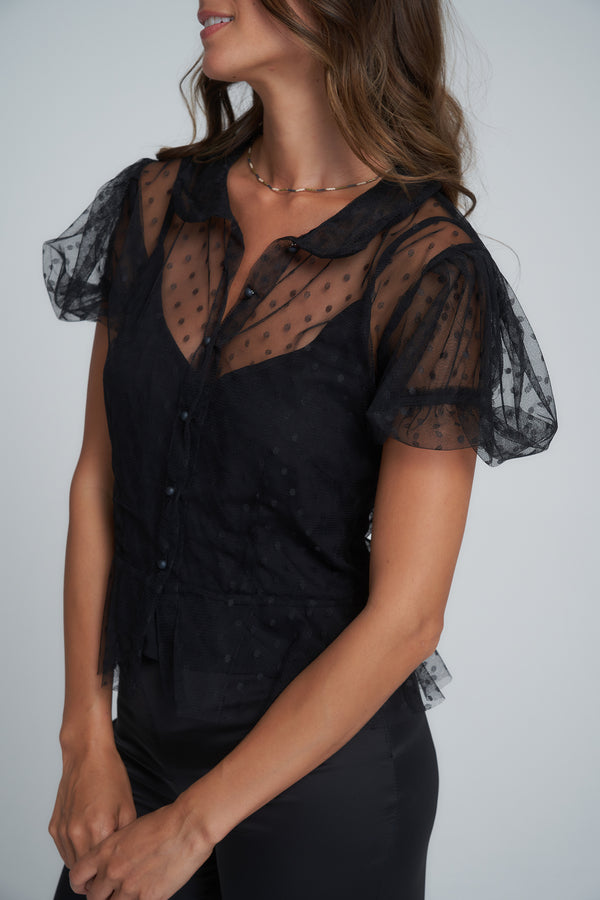 A model wearing a feminine black lace top