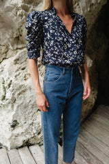 Model wears high-waisted straight-leg style jeans