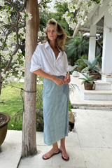 Model wears the wrap midi skirt in a handpainted blue, green print for summer