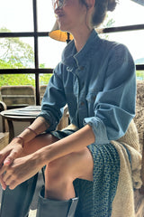 a model wearing retro print skirt and denim jacket