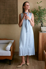 Model in light blue midi dress with v neckline