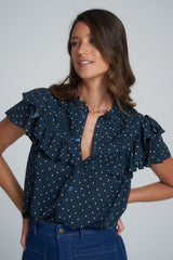 A model wearing a navy print ruffle top