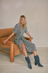 Model wears ditsy floral midi dress with waist tie