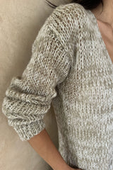 Close up detail of open weave knit cardigan