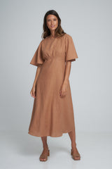A woman wearing a brown linen maxi dress