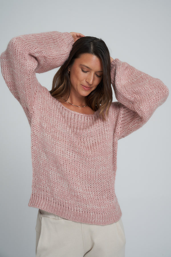 A model wearing an oversized pink jumper