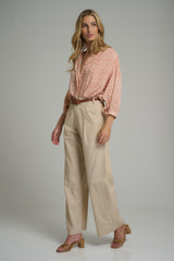 A woman wearing beige dress pants