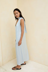 Model wears blue satin shift midi dress