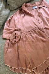 Flat lay of silky satin set with embroidered scallop edge