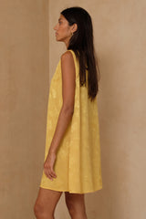 Yellow jacquard mini dress with V neckline and wide shoulder straps