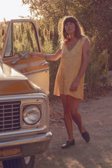 Olivia wearing the yellow jacquard mini dress from SS26 LILYA