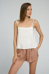 Close-up of ruffled hem and delicate lace trim on the Icaria Top