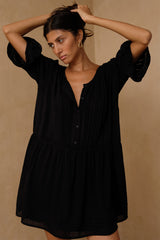 Black mini dress with pintuck detailing and relaxed silhouette