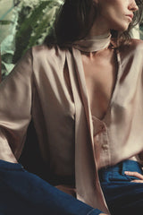 Model wears silky satin viscose top with neck tie