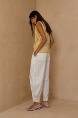 White cotton pants with adjustable ankle and brass stud detailing