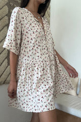 Model wears easy feminine dress with soft drape and relaxed silhouette
