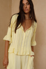 A light yellow pleated top by LILYA