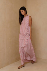 Relaxed striped maxi dress styled casually with flat sandals for warm-weather dressing