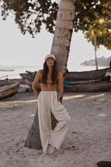 Fenton Pants in Natural paired with Bikinis at the beach.