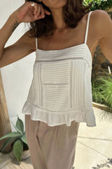 Lady wears white Icaria top with pleating detail