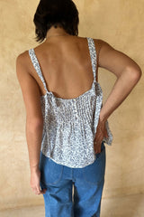 Back view of feminine summer camisole with tie strap and button detail, designed for holidays and warm weather