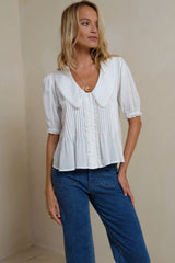 Front view of pintuck-detail ivory top