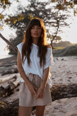 Model wearing straight-fit linen mini skirt in neutral sand