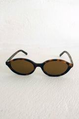 Sunglasses with tortoiseshell frame and brown lenses on a white background