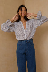 Relaxed floral top with tie sleeve accents and scooped hem