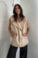 Girl styles Shearling vest with black jeans for stylish winter look