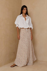 Oversized white cotton shirt styled with flowing floral maxi skirt