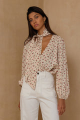 Soft feminine floral top with tie neckline and easy drape