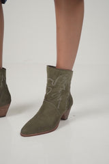 A model wearing the Canyon Boot in Tapenade by LILYA