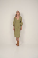 A model wearing a green wrap midi dress