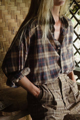 Checked oversized shirt paired with relaxed tailoring and sandals