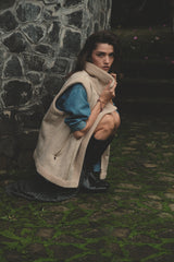 Model wears shearling vest in oat colurway on winter weekend away