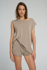 Neutral sleeveless top with contemporary neckline