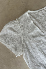 Relaxed feminine top designed for movement and lightweight layering