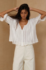 Relaxed ivory blouse with button-through front and soft drape