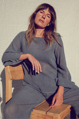 Olivia styling the Allegra mesh top with flared sleeves and an open weave knit.